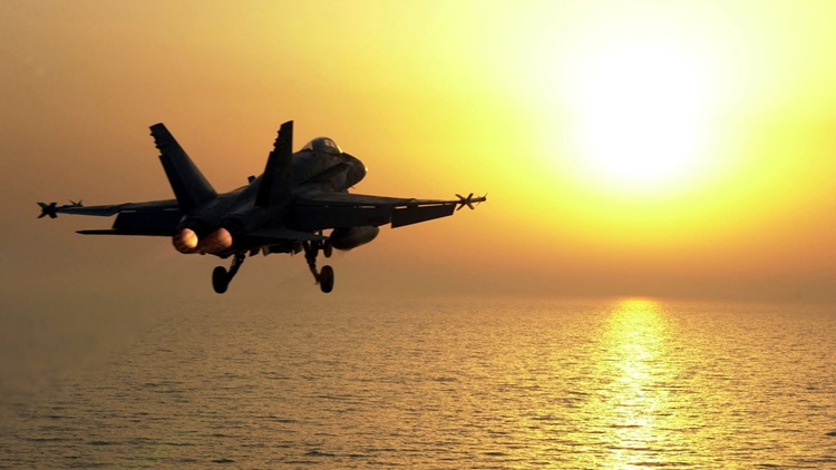 F-18 flying sunset